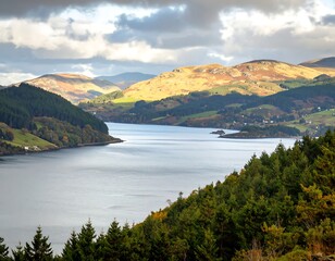 Serene loch nestled in autumnal hills, sunlight illuminating slopes