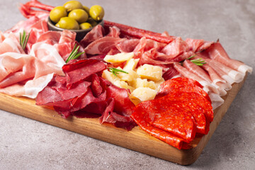 Charcuterie board. Antipasti appetizers of meat and cheese platter with salami, prosciutto crudo or jamon and olives