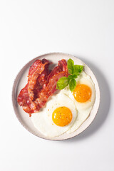 Delicious traditional English breakfast with fried eggs and bacon