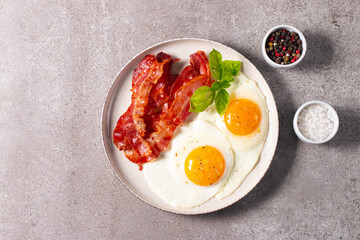 Delicious traditional English breakfast with fried eggs and bacon