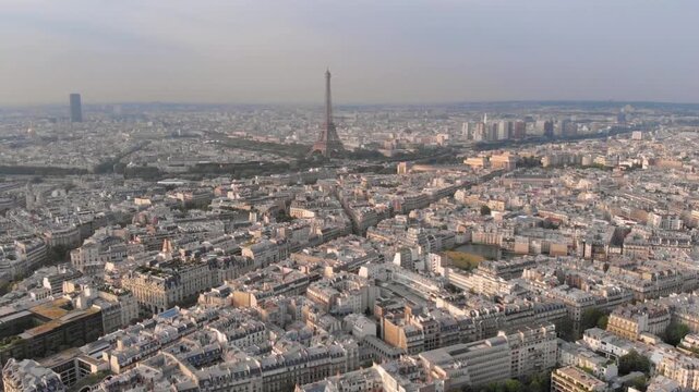 An aerial view of paris shows the eiffel tower rising above the cityscape