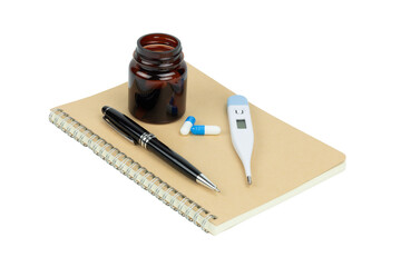 Medical concept with digital thermometer, blue and white medicine pills, and a notebook with a pen, isolated on white background with clipping path.
