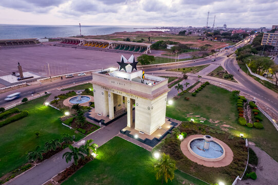 Aerial view of Accra Ghana Black Star Gate illuminated at dusk, landmark monument.