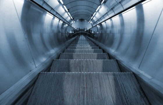 Fototapeta Electric escalator in metro. Moving staircase.