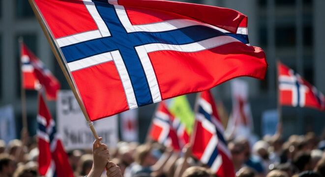Hand holding a Norway flag waving in crowd. Norwegian person celebrating national day. Patriotism and national pride concept. - Powered by Adobe