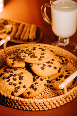 Freshly baked chocolate chip cookies with milk served in a cozy setting