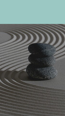  A serene, minimalist composition of three large, weathered gray rocks arranged in a harmonious balance upon a smooth, pale beige sandy surface. The rocks, the main subjects, are distinguished by text