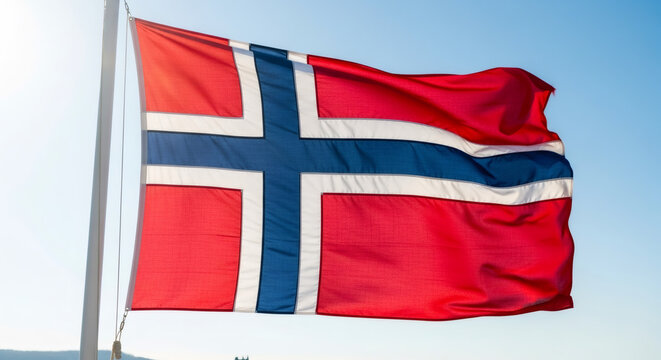 Norwegian flag waving high on flagpole. Patriotism symbol and national identity.