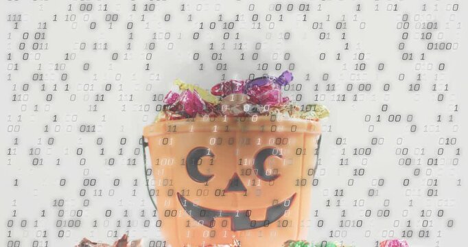 Binary digits appearing over orange pumpkin bucket of candy, wrappers tumbling showing data flood