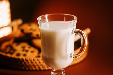 Warm milk served with chocolate chip cookies in a cozy setting