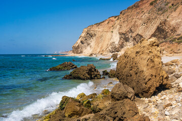 Majestic cliffs rise above the azure sea. The sky and the sea meet in endless blue. The beauty of the coast radiates harmony and peace.