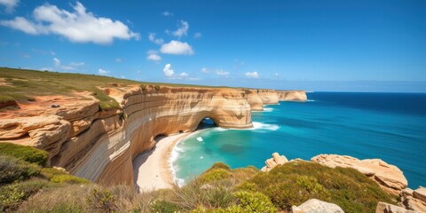 Obraz premium Coastal cliffs and hidden beach reveal stunning Algarve scenery in Portugal.