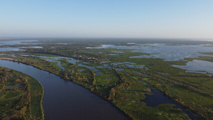 Aerial view river lake in middle trees blue sky near to sea, Cienaga  © Camilo