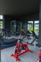 Modern gym with exercise equipment and indoor cycling bike