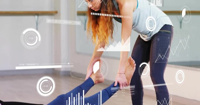 Fitness instructor placing hands under ankles, guiding stretch for flexibility with floating gauges - Powered by Adobe