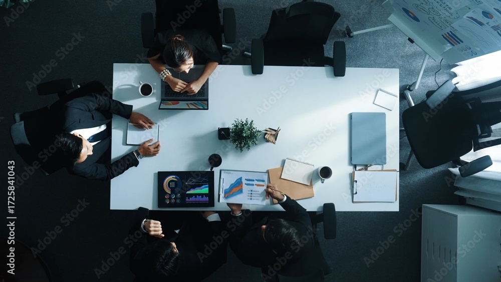 Poster top view of smart diverse team walk at meeting table and start to discuss about financial statistic.