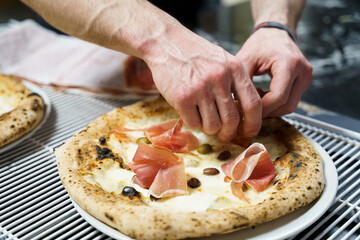 Italian prosciutto pizza with mozzarella and olives