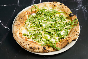 White pizza with arugula and cheese