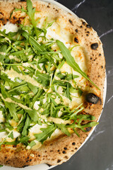 White pizza with arugula and cheese
