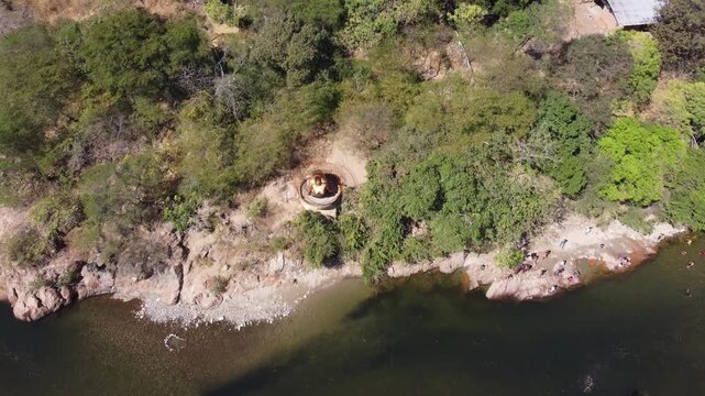 aerial drone view valledupar river in colombia. statue near river, clear water