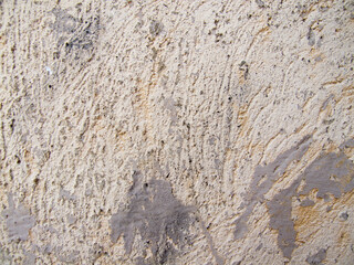 Old textured stone wall with rough gray granite surface background