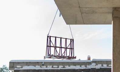 A crane lifts plastic windows at a construction site