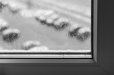 View of the parking lot in winter through the window