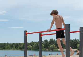 A little boy is engaged in gymnastics equipment