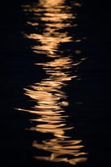 Abstract reflection of full moon light on the sea waves