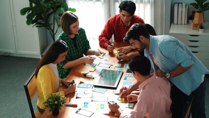 Top view of male leader present Ux Ui idea while standing at meeting. Diverse startup manager in...