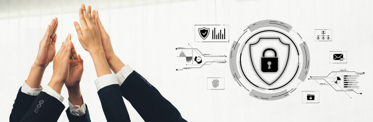 Diverse professionals raise their hands together, symbolizing collaboration in a modern office....