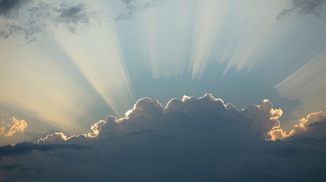 Sunlight streams through a dramatic cloud formation, highlighting the soft, diffused light.