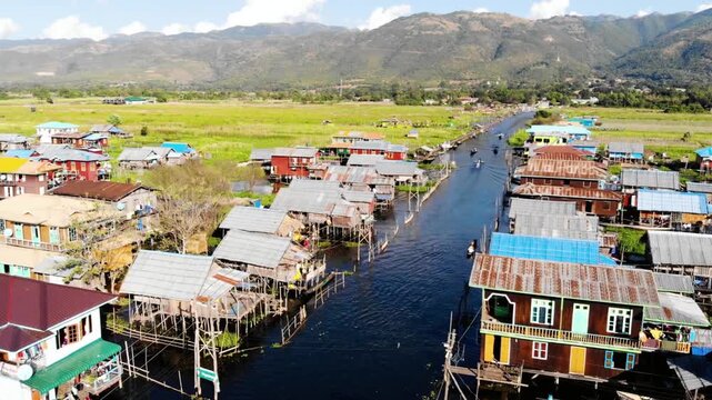 Aerial view of houses on stilts over inle lake in myanmar on a sunny day