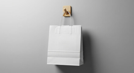 Stylish shopping bag mockup hanging on hook with neutral background, ideal for branding, packaging design, retail identity, advertising display, and creative product presentation