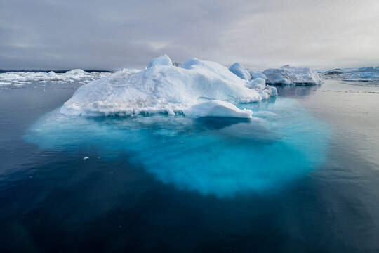 An iceberg visible above and beneath the ocean surface.