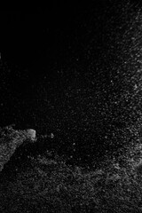 Obraz premium Abstract view of white and blue particles floating against a black background, resembling stars in space or underwater bubbles in darkness.