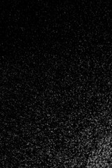 Abstract view of white and blue particles floating against a black background, resembling stars in space or underwater bubbles in darkness.