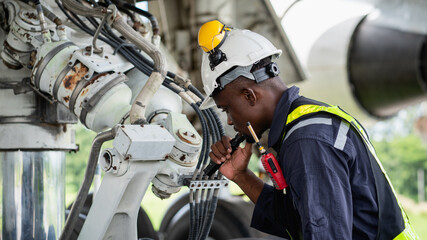 Aircraft maintenance engineer inspecting airplane engine with safety equipment and tools, aviation mechanic ensuring aircraft repair, safety check, and technical engineering service.