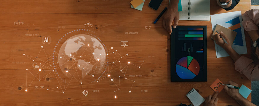A dynamic business meeting scene showcasing collaboration, data analysis, and innovative technology, with visuals of charts and global connectivity on a wooden desk. Trope - Powered by Adobe