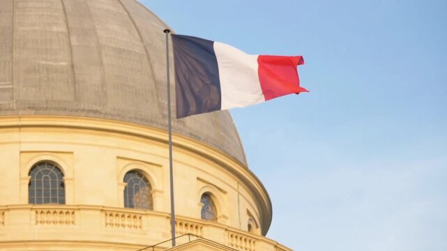 The french flag waves proudly in front of the panthon in paris