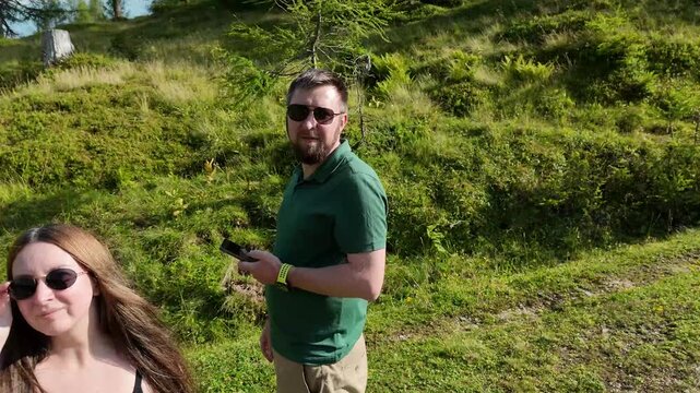 Couple hiking in alpine mountains enjoying summer nature landscape - Powered by Adobe