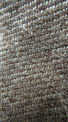 Close-up texture of brown woven fabric material with textured fibers - use concept for textile designers, interior decorators, fashion brands