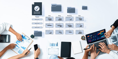 A modern office environment showing a team working collaboratively with digital tools for project...