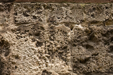 Weathered limestone wall surface with natural texture
