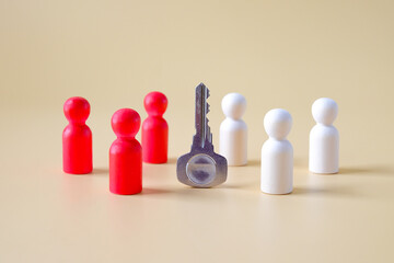 Wooden figure standing circle around the key.Business , teamwork, team spirit.