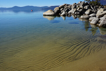 panoramic view of clear water, rocks and sand in beautiful lake Tahoe, Ca, USA, on a sunny day in Sand harbor