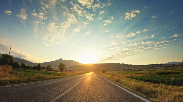 Sunrise, valley, agricultural land, POV drive asphalt road, railway crossing