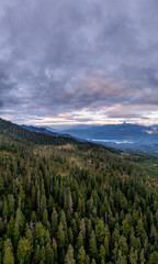 Obraz premium Aerial View Of Forested Mountains Overlooking A Valley And Lake In British Columbia