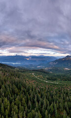 Expansive Forested Valleys and Mountain Range Under Sunset Sky in British Columbia