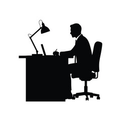 Man working at desk with lamp and laptop a dramatic silhouette